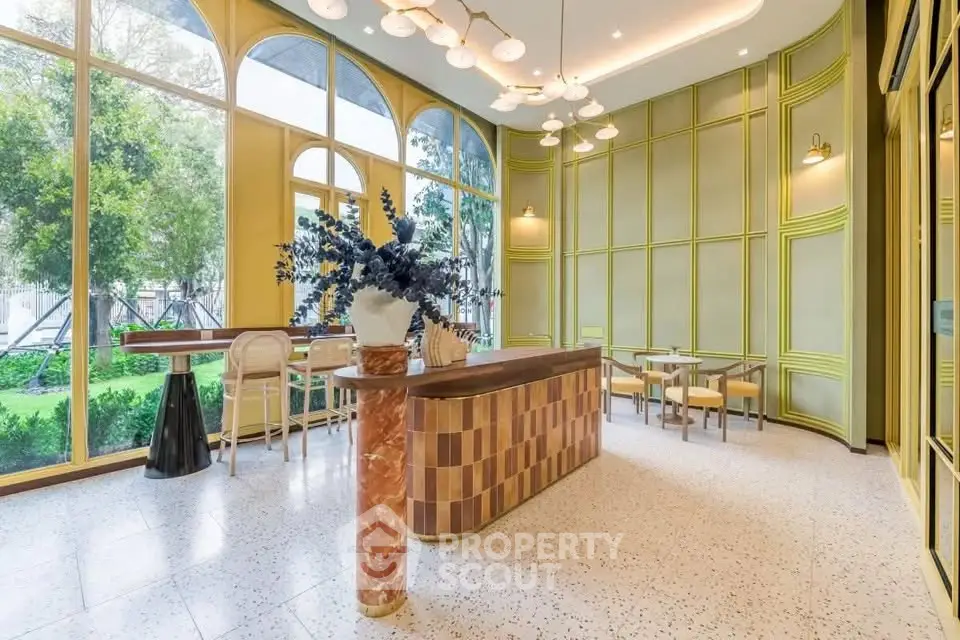 Elegant modern interior with large windows and stylish decor, perfect for a chic cafe or lounge area.