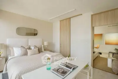 Elegant bedroom with modern decor and sliding door to cozy living area