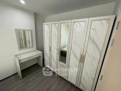 Elegant bedroom with stylish wardrobe and vanity set, featuring modern design and ample storage space.