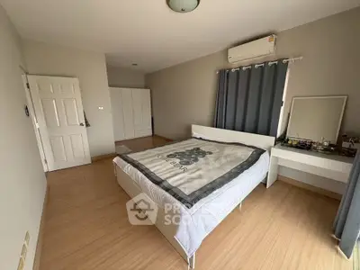 Spacious bedroom with modern decor and natural light