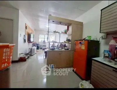 Spacious open-layout living area with modern kitchen and ample natural light.