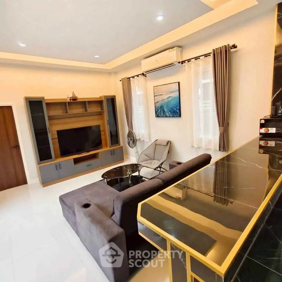 Modern living room with stylish furniture and entertainment center