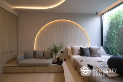 Luxurious modern bedroom with stylish lighting and cozy seating area