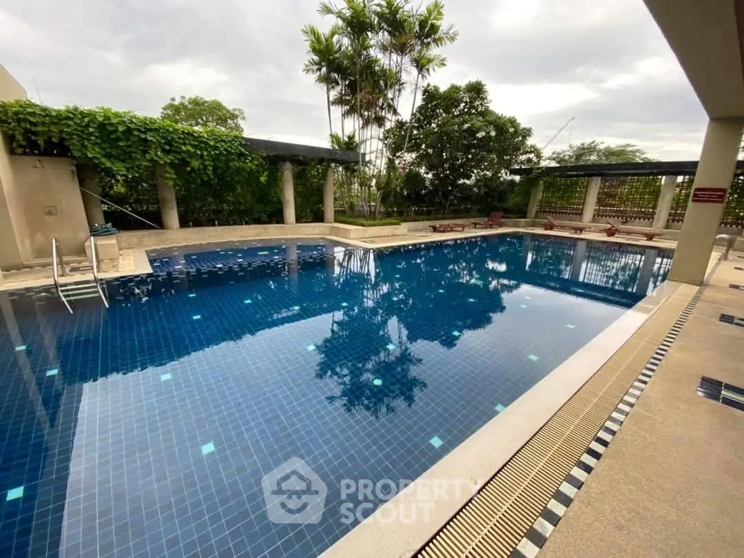 Luxurious outdoor pool with lush greenery and serene ambiance
