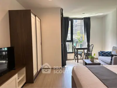 Modern studio apartment with cozy living area and natural light