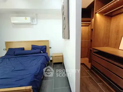 Modern bedroom with walk-in closet and sleek wooden furniture
