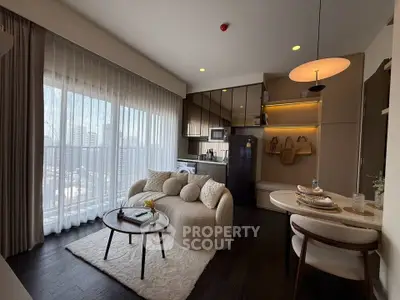 Modern living room with open kitchen and city view, featuring elegant furniture and natural light.