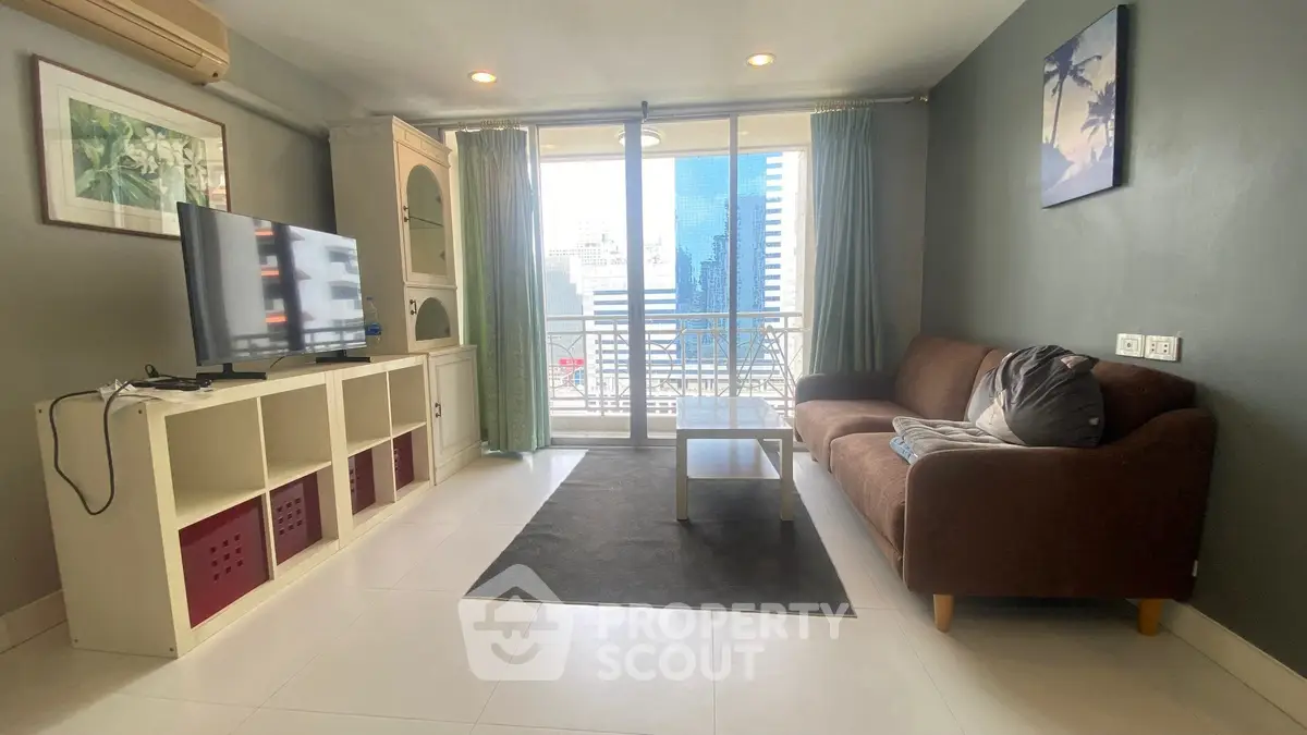 Modern living room with city view, cozy sofa, and large TV, perfect for urban living.