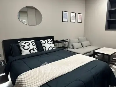 Modern bedroom with stylish decor and cozy seating area