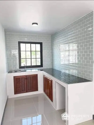 Modern kitchen with sleek countertops and stylish tiled backsplash