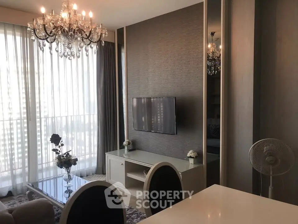 Elegant living room with chandelier and modern decor in a luxury apartment.