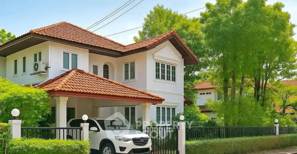 Charming two-story house with red-tiled roof and lush greenery, featuring a spacious driveway and modern design.