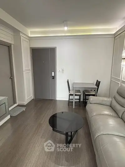 Modern living room with sleek furniture and neutral tones, perfect for a cozy urban lifestyle.