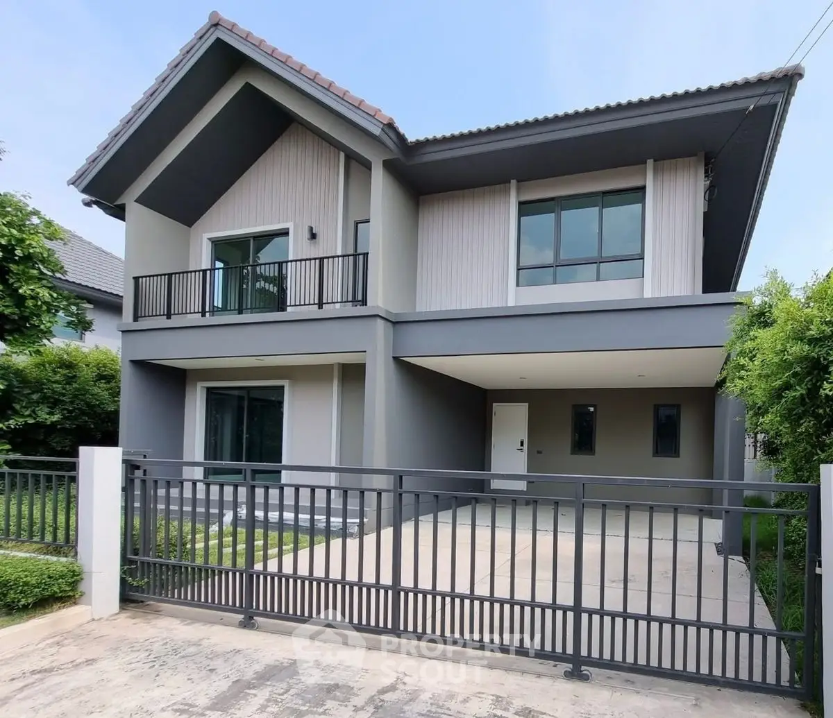 Modern two-story house with sleek design and spacious driveway in a serene neighborhood.