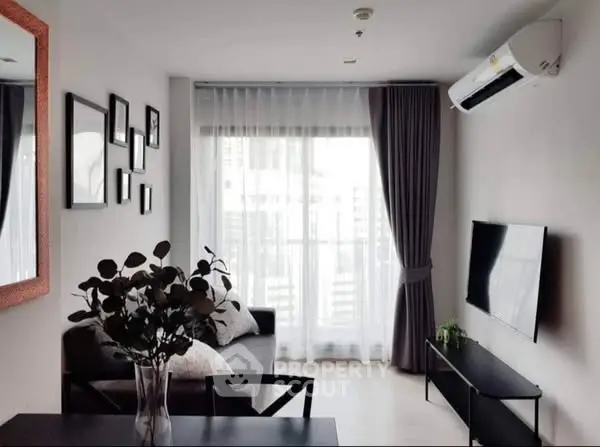 Modern living room with sleek furniture and large window for natural light.