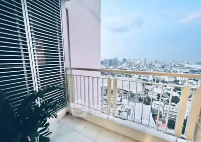 Stunning city view from a modern balcony with sleek railing and tiled floor.