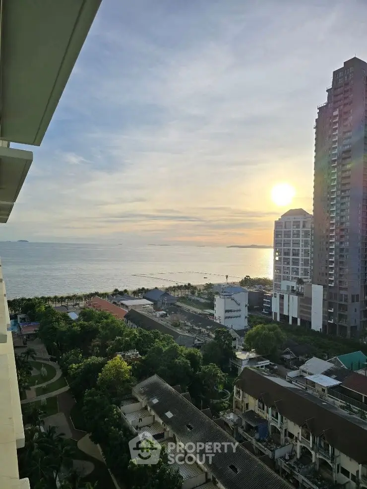 Stunning ocean view from high-rise balcony at sunset, perfect for serene living.