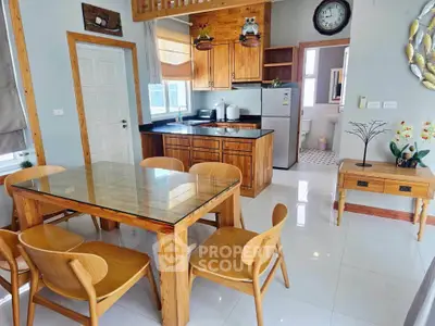 Charming open-layout kitchen and dining area with wooden furniture and modern appliances.