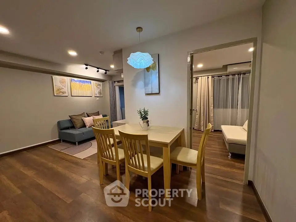 Stylish open-plan living and dining area with modern decor and warm lighting.