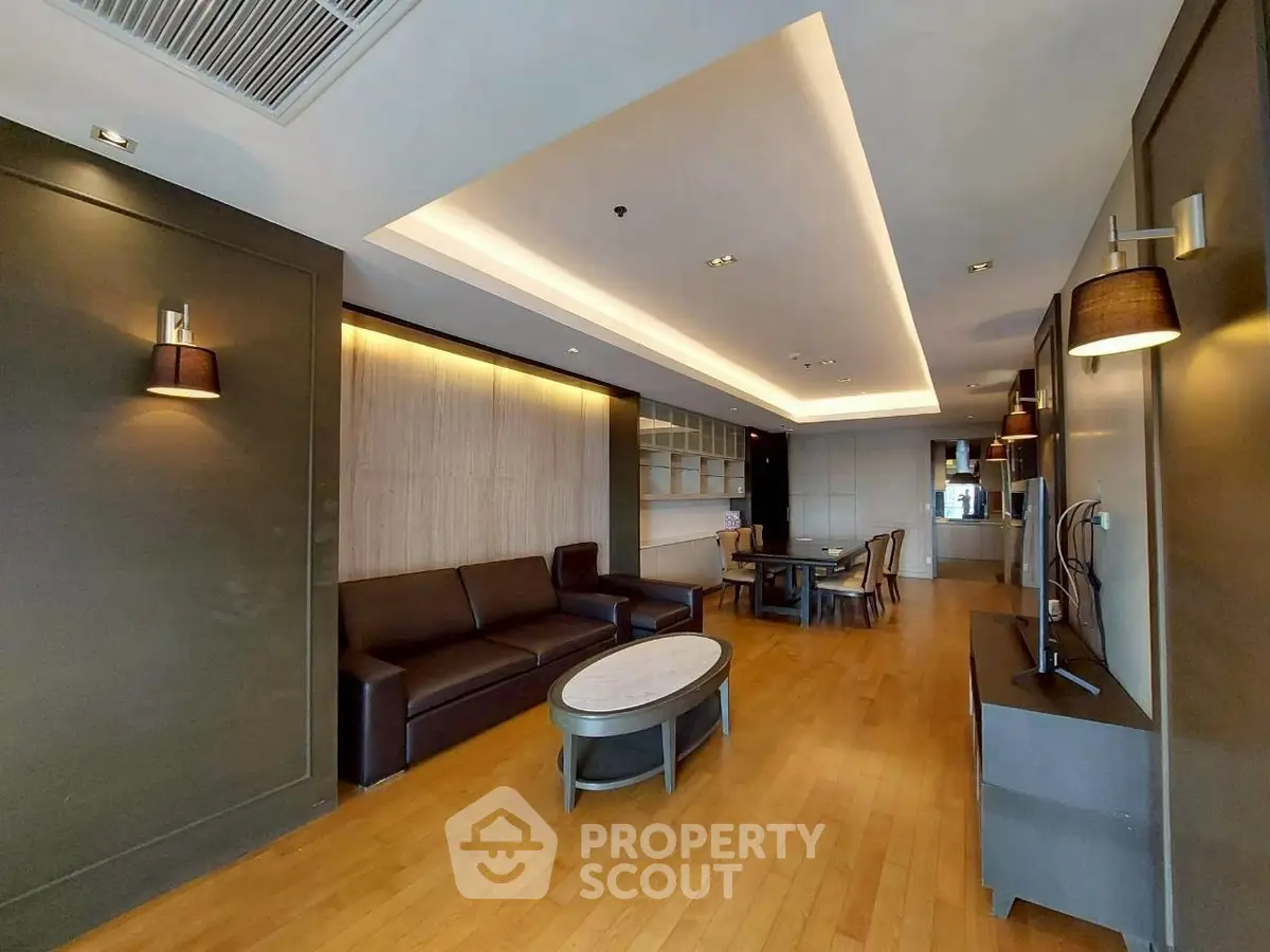 Spacious modern living room with elegant lighting and hardwood floors