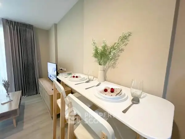 Modern living room with stylish dining setup and TV, perfect for cozy gatherings.