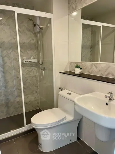 Modern bathroom with sleek shower and stylish sink in contemporary design.