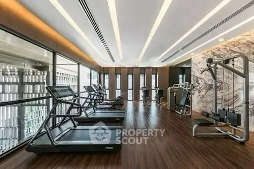 Luxurious modern gym with state-of-the-art equipment and sleek design.