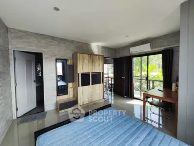 Spacious bedroom with balcony access and modern furnishings in a serene setting.