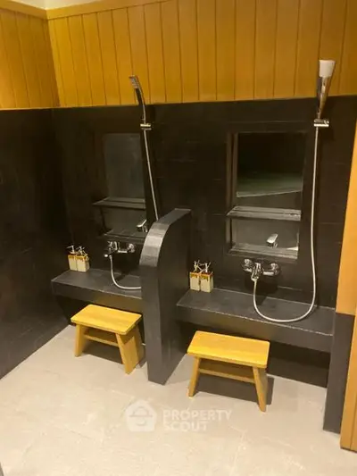 Modern bathroom with dual shower stations and wooden accents