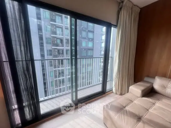 Modern apartment with large windows offering stunning city views and sleek interior design.