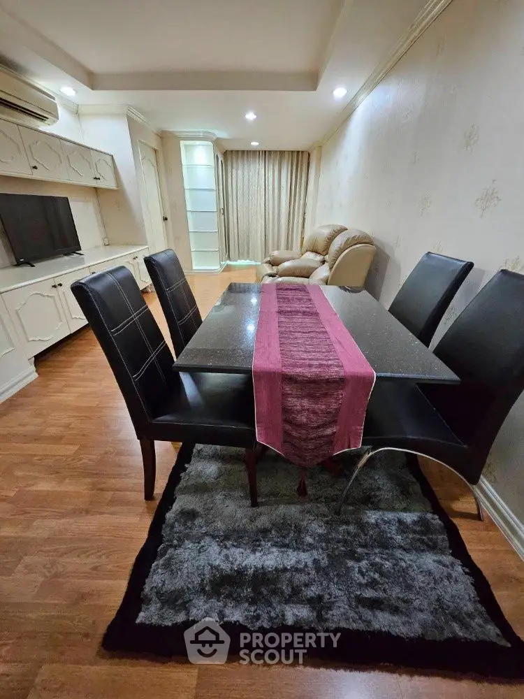 Elegant living room with dining area, featuring modern furniture and cozy ambiance.