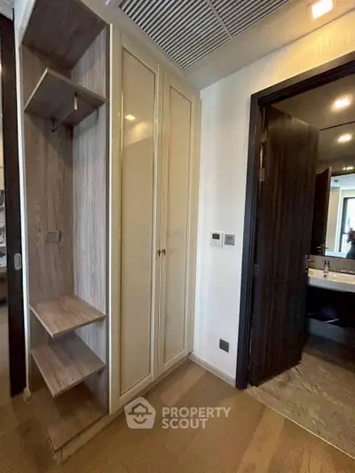 Modern apartment interior with sleek storage and bathroom view