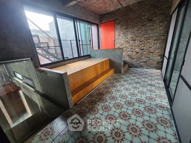Stylish industrial loft with unique brick wall and patterned tile flooring