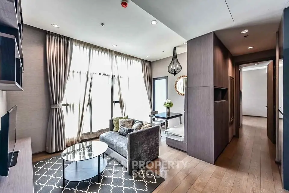 Modern living room with elegant decor, large windows, and stylish furniture in a luxurious apartment.