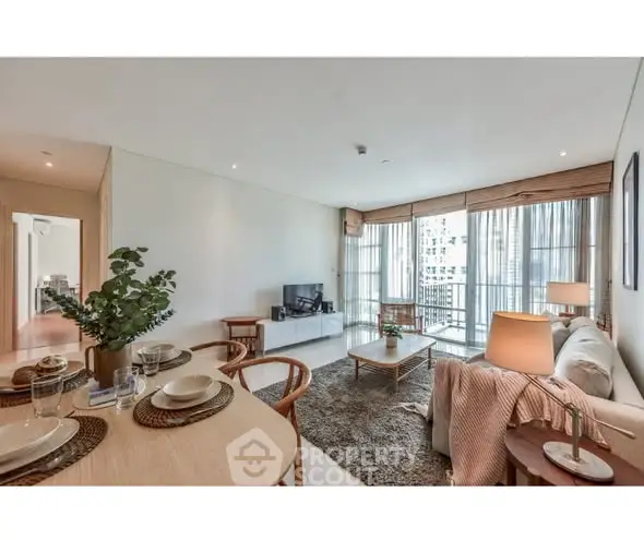 Spacious modern living room with elegant decor and city view, perfect for urban living.