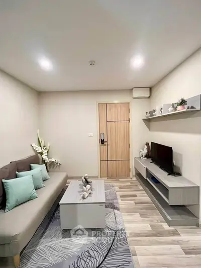 Modern living room with stylish decor and cozy ambiance, featuring a sleek sofa and entertainment unit.
