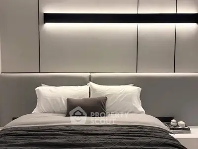 Luxurious modern bedroom with elegant lighting and plush bedding