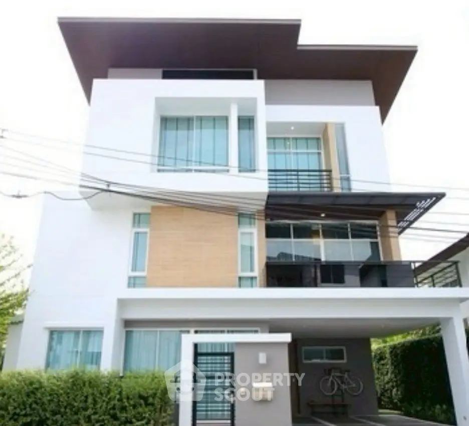 Modern multi-story house with sleek design and large windows