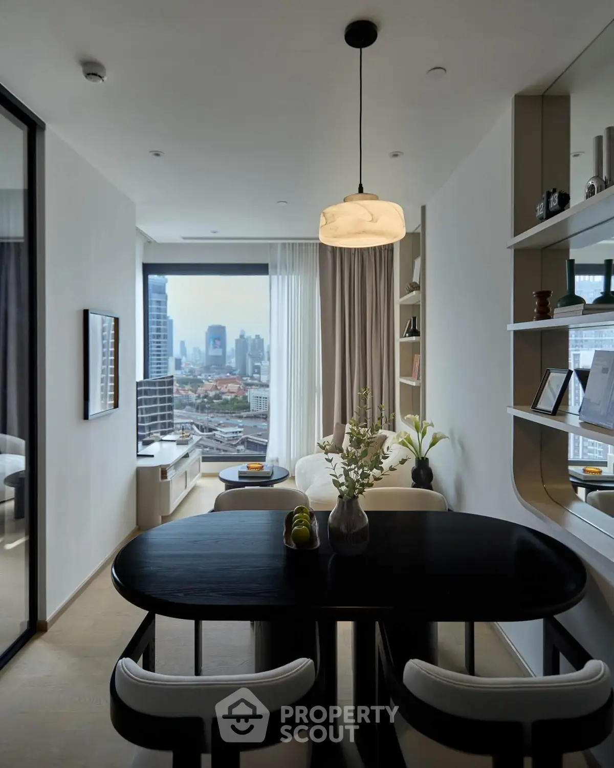 Modern living room with city view, elegant dining table, and stylish decor in a high-rise apartment.