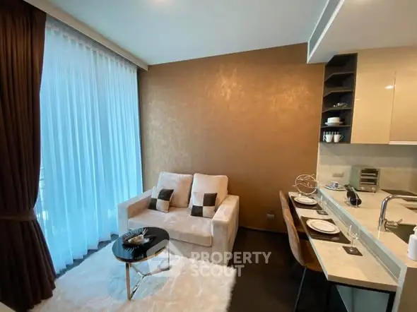 Modern living room with cozy seating and elegant dining area in open layout apartment.