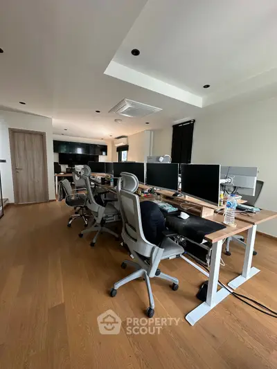 Modern study room with ergonomic chairs and multiple computer setups, ideal for productivity.
