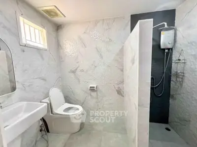 Modern bathroom with sleek design and shower area in a contemporary home.