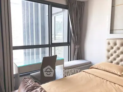 Modern bedroom with large window and stylish furniture in urban apartment.