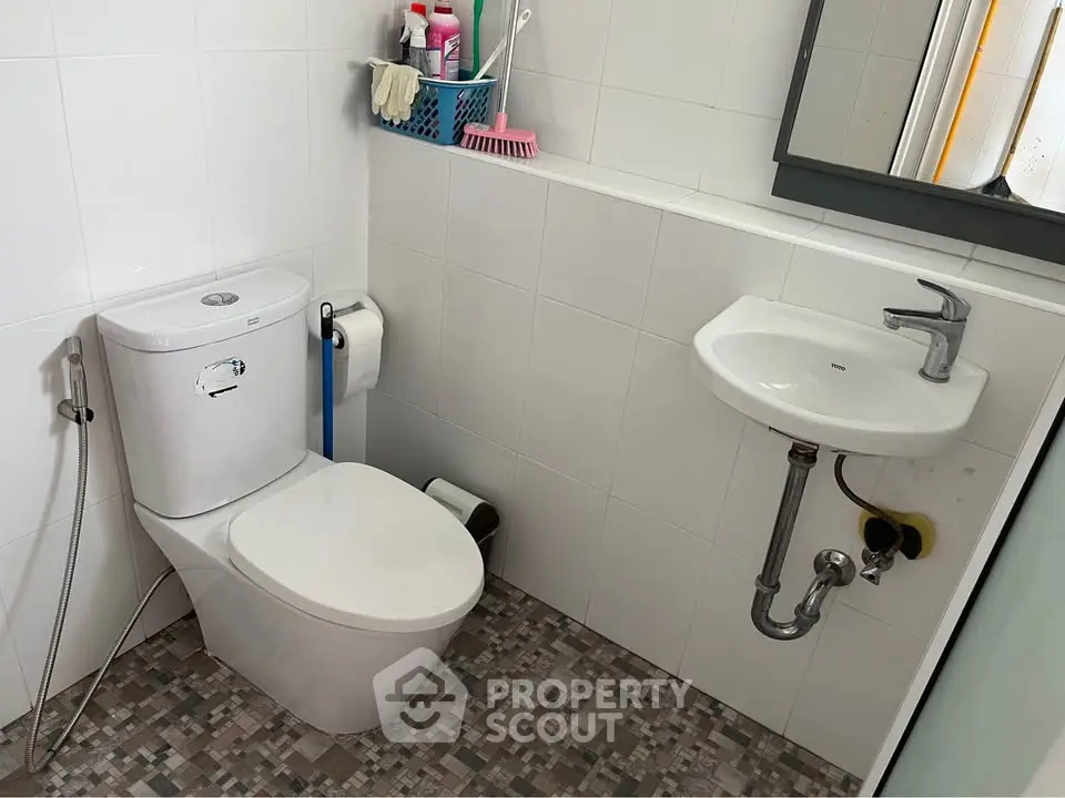 Modern bathroom with sleek fixtures and tiled flooring