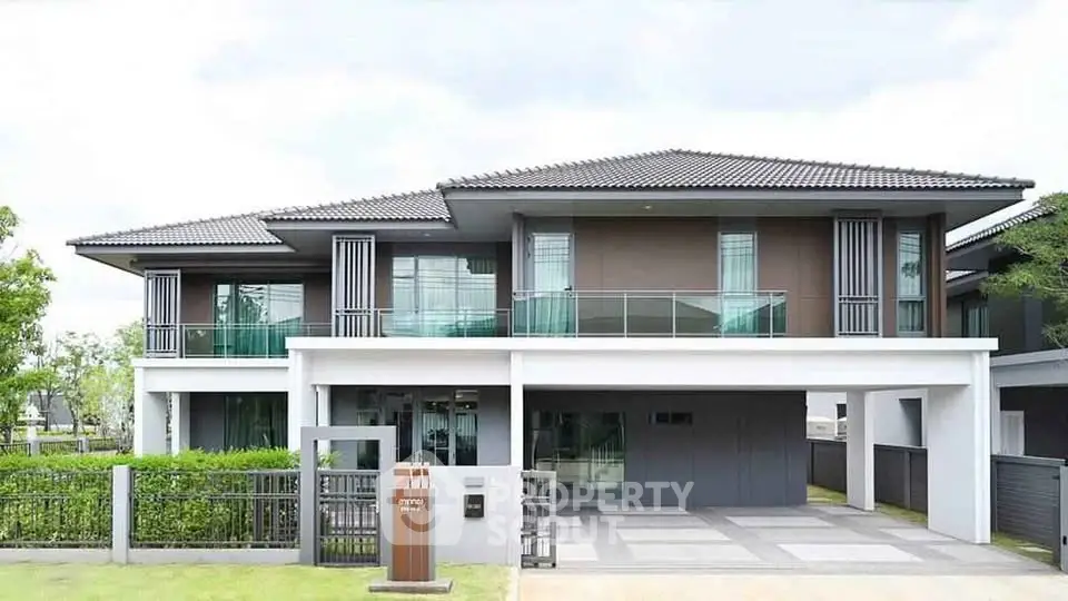 Luxurious modern two-story house with sleek design and spacious driveway