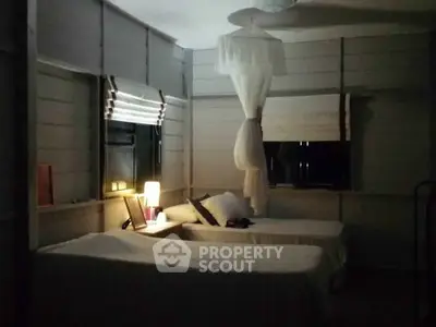 Cozy bedroom with twin beds and ambient lighting in a serene setting.