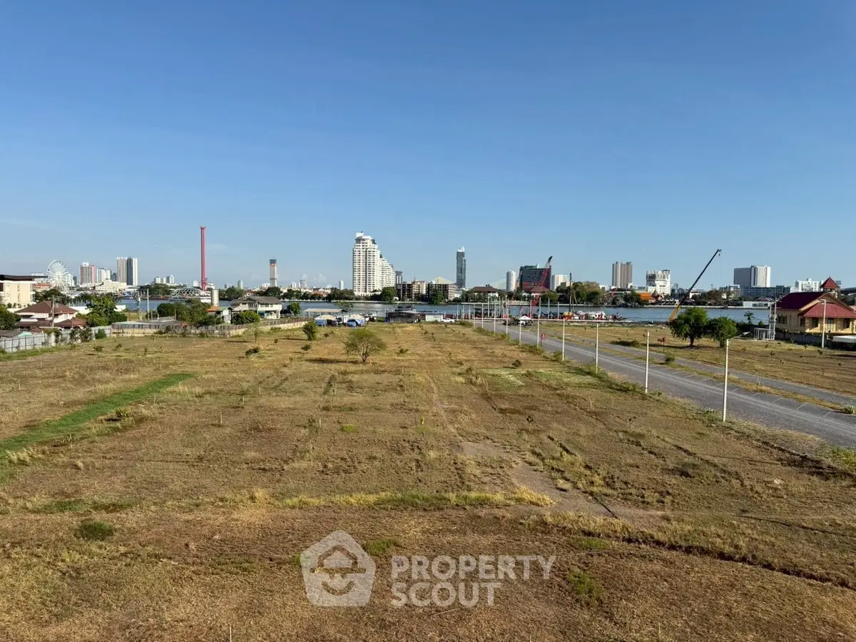 Expansive land plot with city skyline view, ideal for development opportunities.