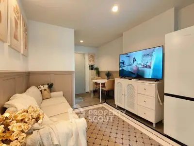 Cozy living room with modern decor and large TV, perfect for relaxation.