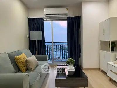 Modern living room with balcony view, stylish furniture, and air conditioning in a high-rise apartment.