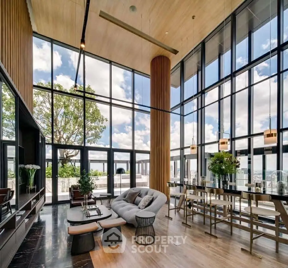 Luxurious modern living room with floor-to-ceiling windows and stunning city view.